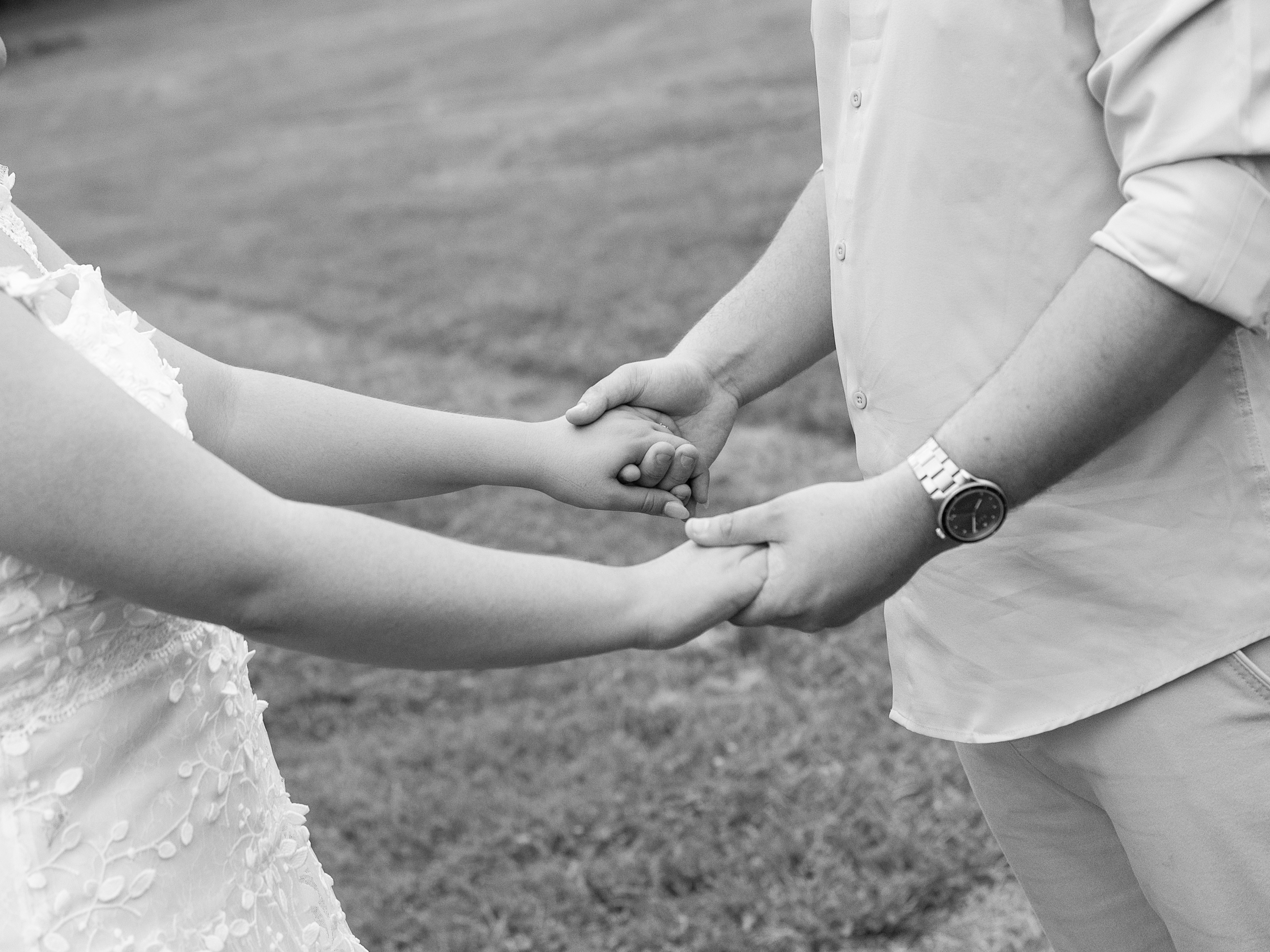 Carolina and Jason holding hands outdoors